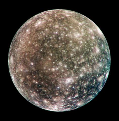 Image of Callisto, Jupiter's moon, covered with bright spots and dark patches, indicating numerous impact craters on its icy surface